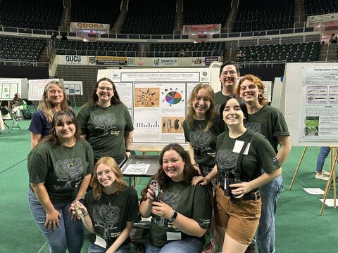 The lab group in front of the window collision poster