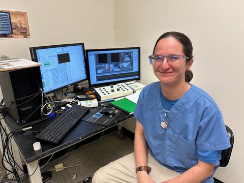 lab technician, Hannah Curtis, sitting at a computer.
