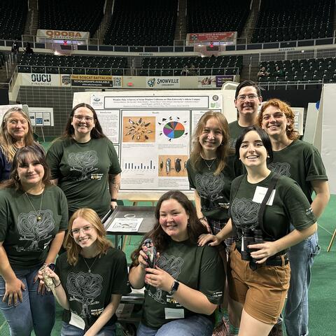 The lab group in front of the window collision poster