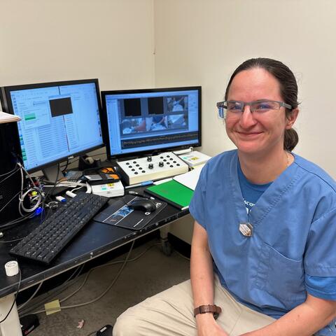 lab technician, Hannah Curtis, sitting at a computer.